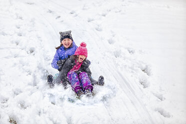 Friends tobogganing downhill - ISF04423