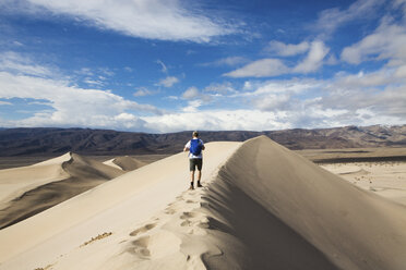 Trekker walking in Death Valley National Park, California, US - ISF04440