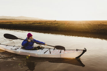 Mittlere erwachsene Frau beim Kajakfahren auf dem Fluss bei Sonnenuntergang, Morro Bay, Kalifornien, USA - ISF04482