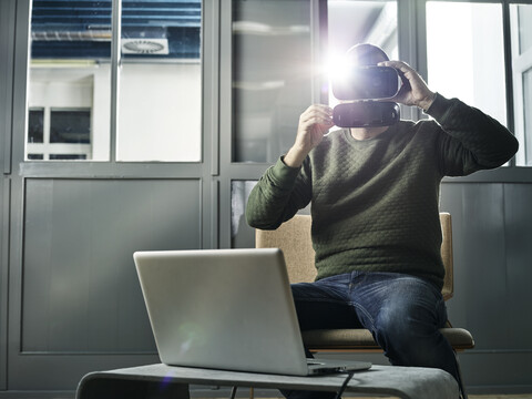 Man working with VR glasses and laptop stock photo