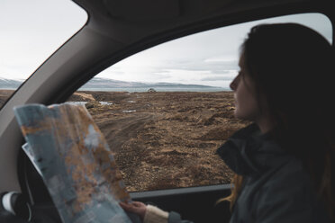 Iceland, young woman in car looking out of window - KKAF01032