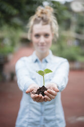 Woman holding seedling - ISF04556