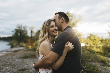 Couple hugging each other on beach, Oshawa, Canada - ISF04591