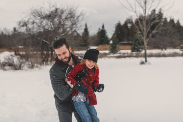 Father and daughter playing in snow - ISF04742