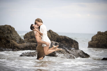 Romantic couple on beach, Malibu, California, US - ISF04818