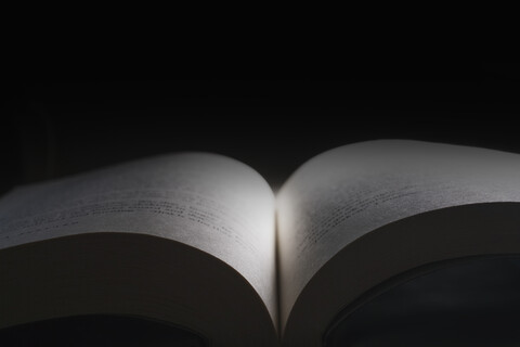 Open book, black background stock photo