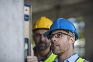 Project manager and construction worker using spirit level - ISF04966