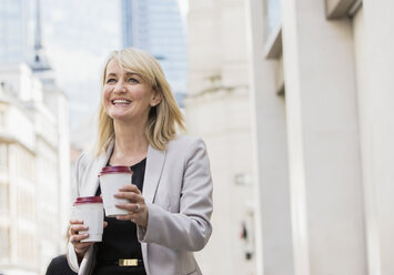 Businesswoman with coffee cups - ISF05012