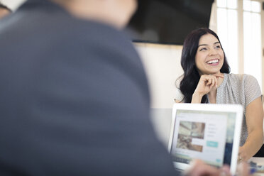 Over shoulder view of young businesswoman at office desk - ISF05148