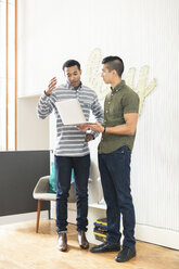 Cool young businessmen in creative office looking at laptop - ISF05166