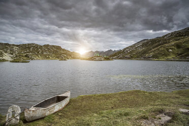 Canoe by lake at sunset, San Bernardino, Ticino, Switzerland, Europe - ISF05206
