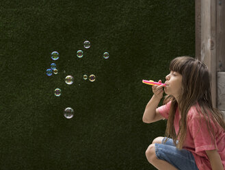 Girl blowing bubbles - ISF05276