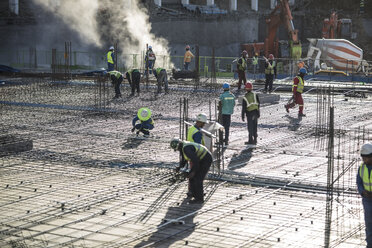 Construction workers laying foundation of building - ISF05618