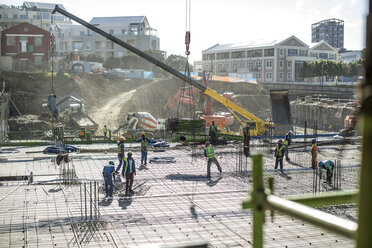 Construction workers laying foundation of building - ISF05623