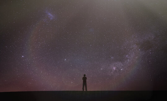 Silhouette of man looking away at starry night sky, Death Valley, California, United States, North America - ISF05631