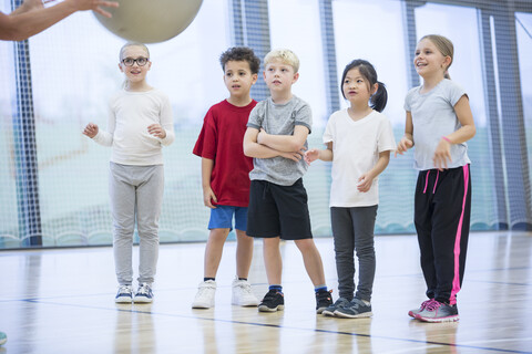 Students in physical education class attentively observing their instructor stock photo