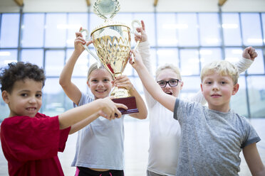 Beaming students proudly display their trophy in the school gymnasium - WESTF24116