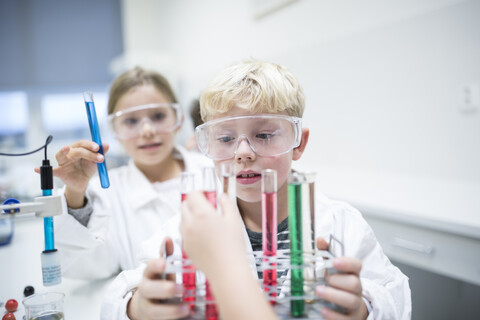 Students conducting experiments with test tubes during a science lesson stock photo