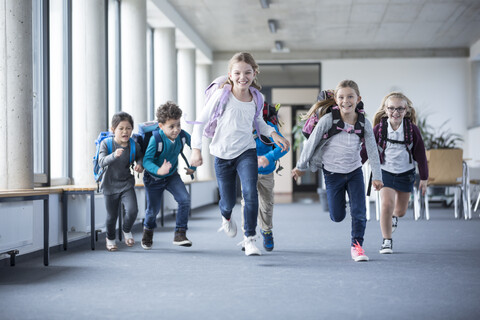Eager students hurrying through the school hallway with enthusiasm and anticipation stock photo