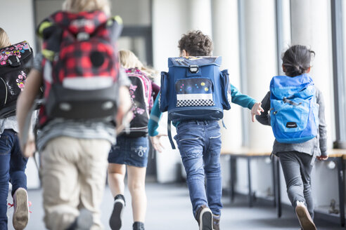 Students hurry down a busy school hallway from a rear perspective. - WESTF24187