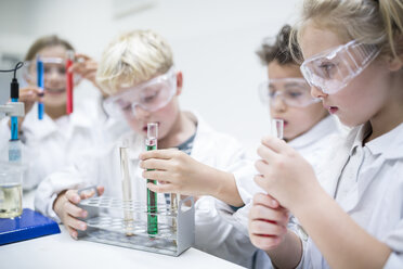 Students conducting liquid experiments in a science classroom using test tubes - WESTF24241