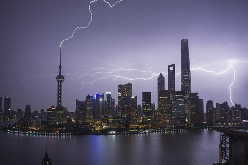 Elevated cityscape with lightning striking oriental pearl tower at night, Shanghai, China - ISF05900