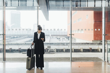 Businesswoman using mobile phone, Milan, Italy - ISF05962