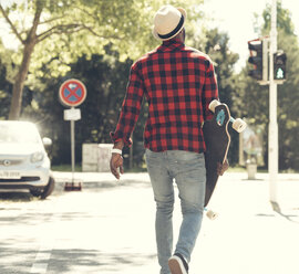 Cool young man with skateboard walking in the city, - UUF13849