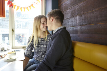 Romantic young couple face to face in cafe window seat - CUF13358