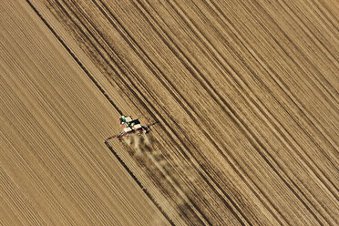 Tractor in field, aerial view, Lausitz, Brandenburg, Germany - CUF13544