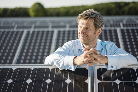 Mature man standing in solar plant stock photo