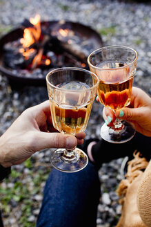 Two people toasting with drinks in wine glasses - CUF13728