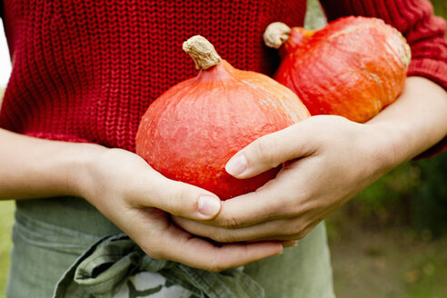 Woman holding homegrown squash - CUF13763