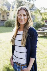 Mid adult woman smiling towards camera, portrait - CUF13814