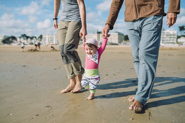 France, La Baule, baby girl walking on the beach with father and grandfather - GEMF02014