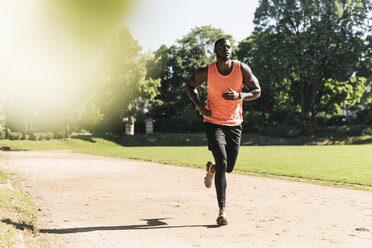 Junger Sportler auf dem Sportplatz beim Lauftraining - UUF13897