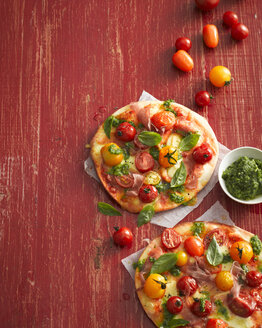 Hochformatige Ansicht von Pizzen mit Tomaten, Basilikum und Prosciutto - CUF13879