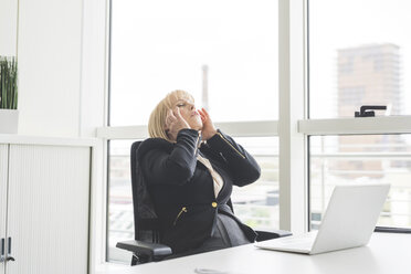 Stressed mature businesswoman at office desk - CUF14087