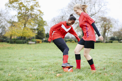 Two female soccer players practicing in park - CUF14594