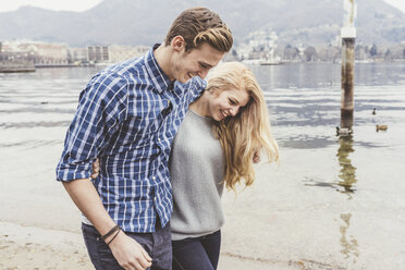 Young couple strolling on lakeside, Lake Como, Italy - CUF14607