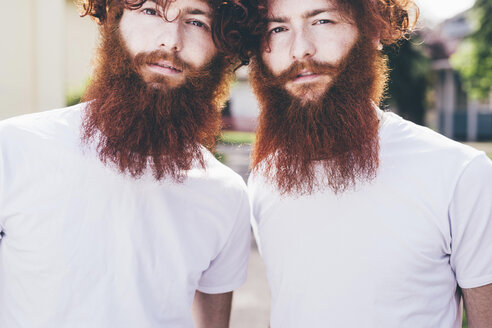 Portrait of young male hipster twins with red beards wearing white tshirts - CUF14648