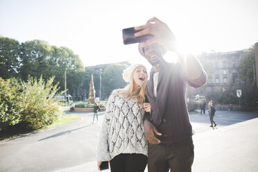 Couple taking selfie with smartphone in park - CUF14993