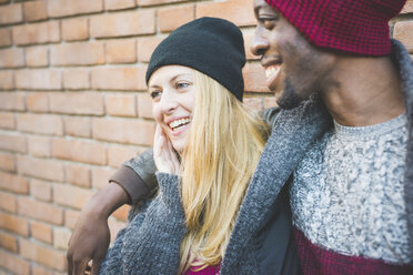 Couple enjoying quiet moment against brick wall - CUF15004