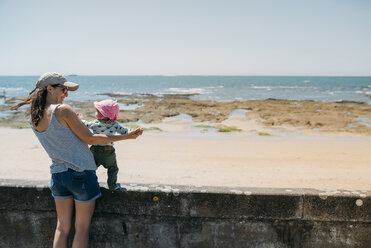 France, mother and baby girl having fun together at beach promenade - GEMF02040