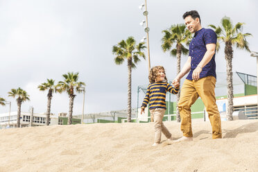 Spain, Barcelona, father and son walking hand in hand on the beach - WPEF00354