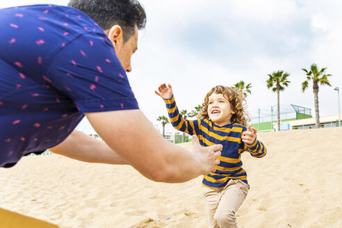 Spain, Barcelona, boy running toward his father on the beach - WPEF00363