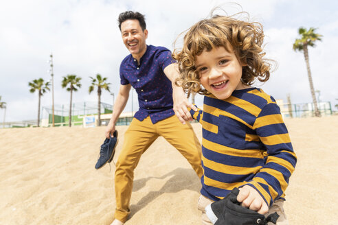 Spain, Barcelona, father and son playing on the beach - WPEF00372