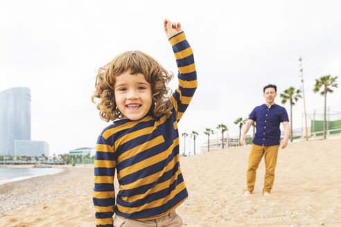 Spain, Barcelona, happy father and son on the beach - WPEF00373