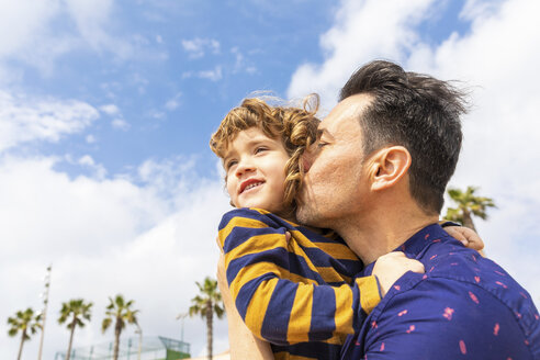 Spain, Barcelona, father kissing son on the beach - WPEF00375