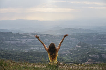 Spain, Barcelona, back view of happy young woman on Montcau Mountain - AFVF00547